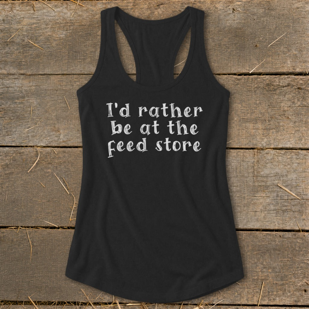 Black racerback tank top with white text that says "I'd rather be at the feed store."