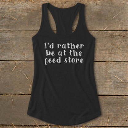 Black racerback tank top with white text that says "I'd rather be at the feed store."