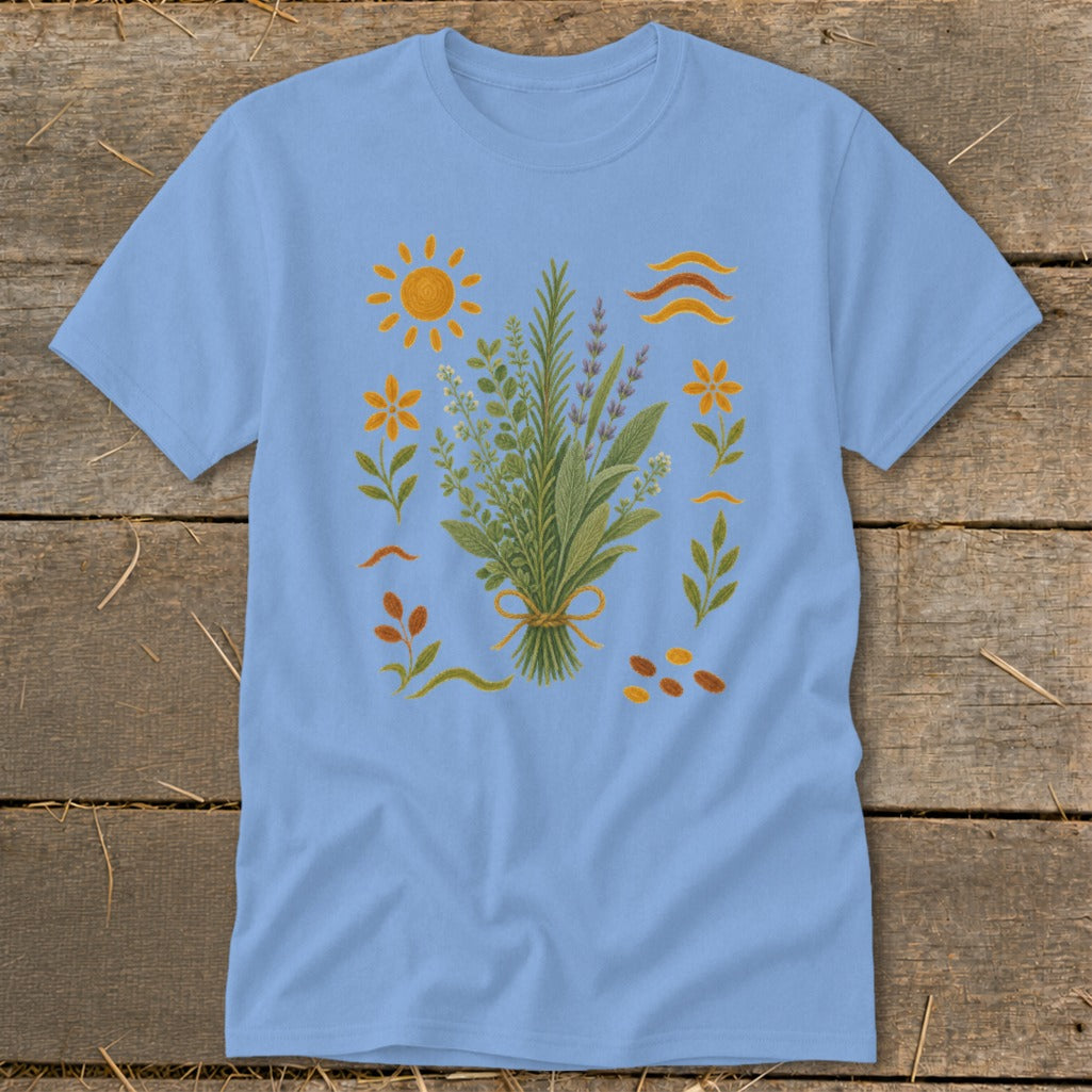 Light blue t-shirt with embroidered bouquet of herbs, sun, and flowers.