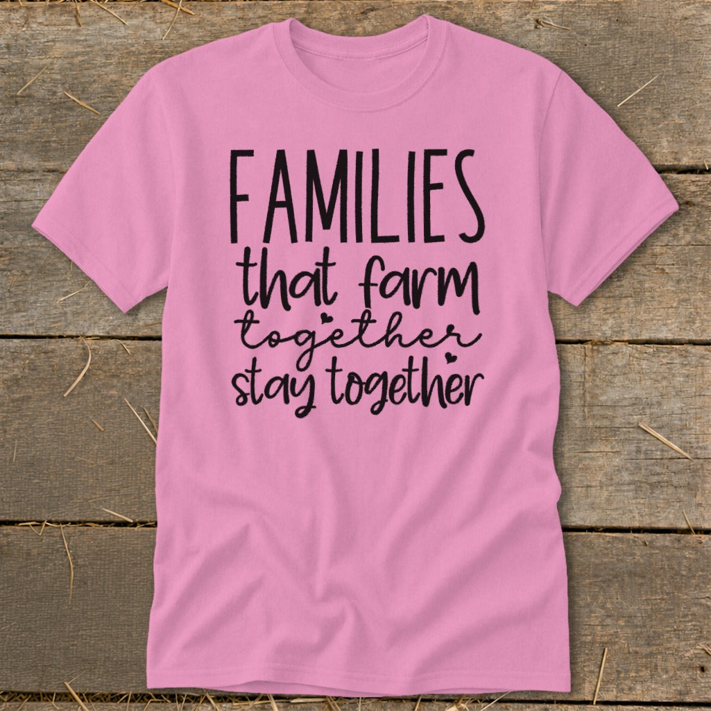 Pink t-shirt with black text that reads "FAMILIES that farm together stay together".