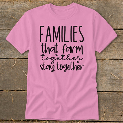 Pink t-shirt with black text that reads "FAMILIES that farm together stay together".