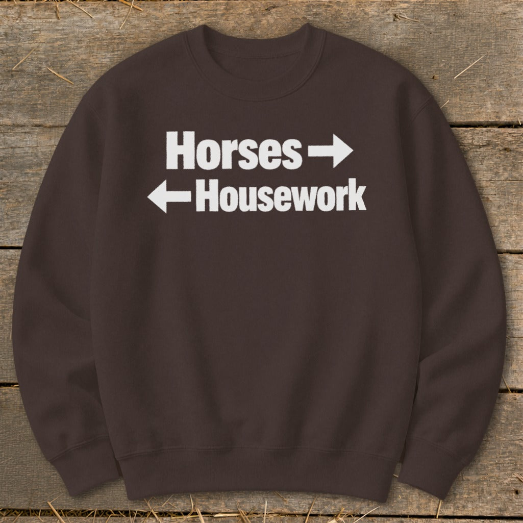 Brown crewneck sweatshirt with white text reading "Horses" pointing right and "Housework" pointing left.