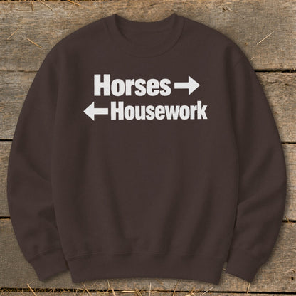 Brown crewneck sweatshirt with white text reading "Horses" pointing right and "Housework" pointing left.