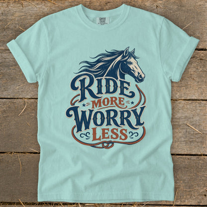 Light blue t-shirt with "Ride More Worry Less" text and horse graphic.