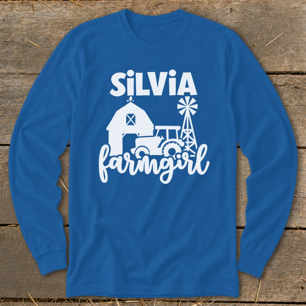 Blue long-sleeve shirt with white text "SILVIA farmgirl" and farm graphics.