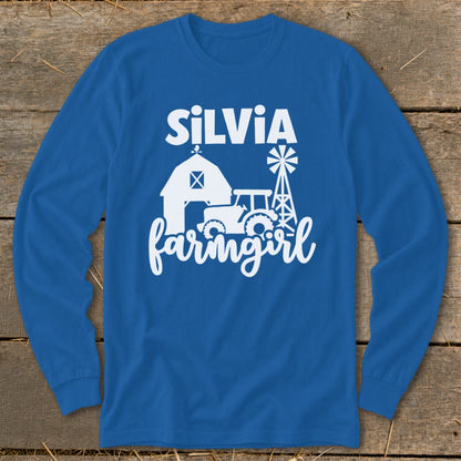 Blue long-sleeve shirt with white text "SILVIA farmgirl" and farm graphics.