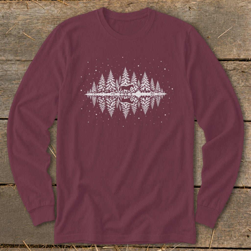 Maroon long-sleeve shirt with white graphic of deer in snowy forest reflected in water.