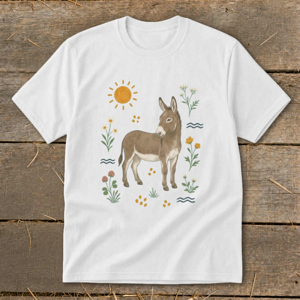 White t-shirt with a watercolor illustration of a donkey surrounded by flowers and a sun.