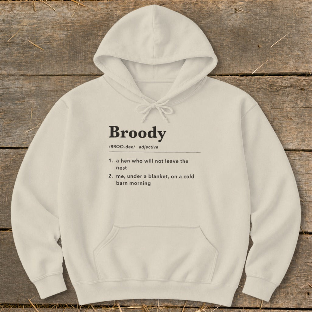 Cream hoodie with "Broody" definition: a hen not leaving the nest or me under a blanket.