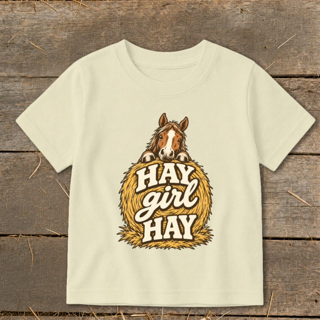 Cream t-shirt with horse on hay bale and "Hay girl hay" text.