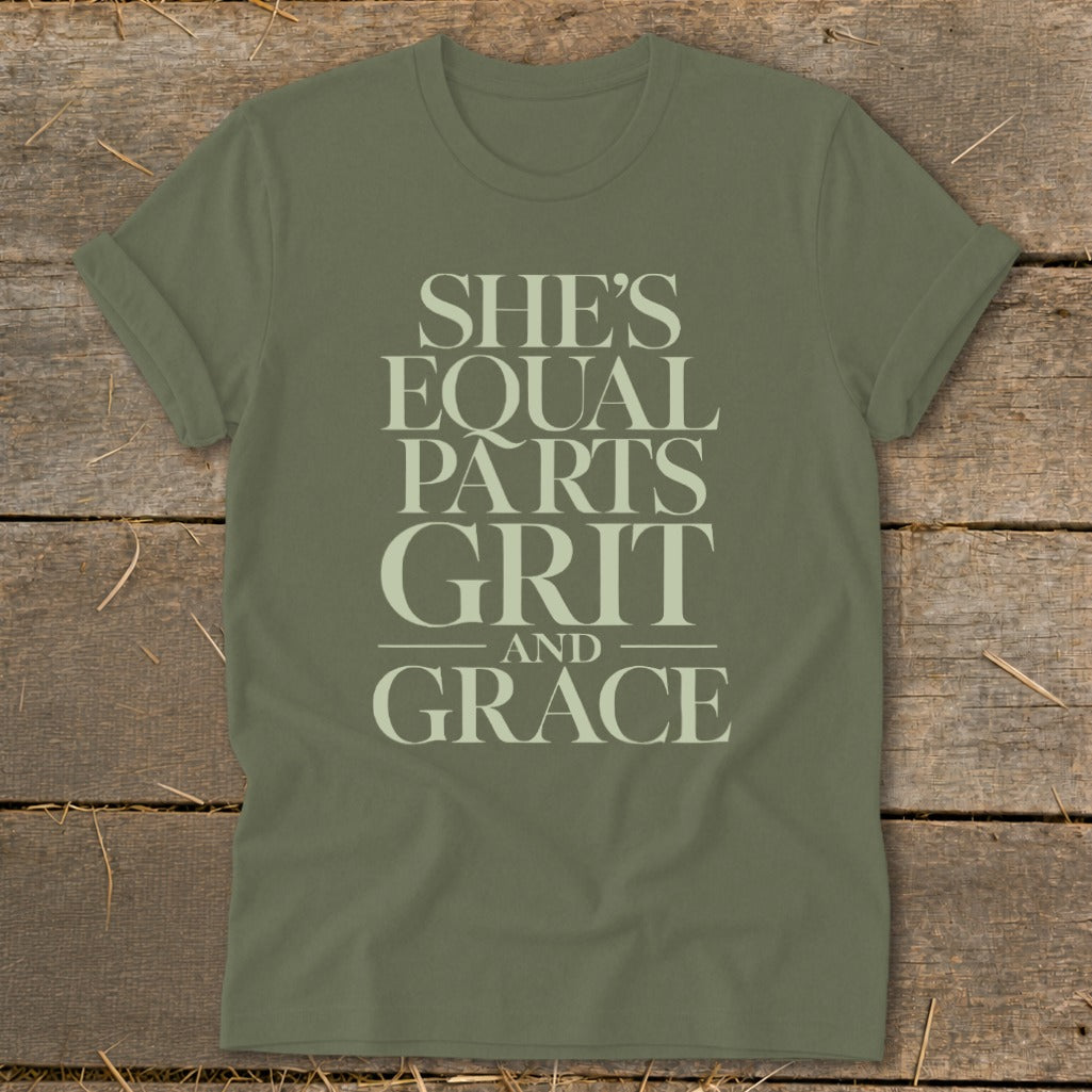 Olive green t-shirt with the text "SHE'S EQUAL PARTS GRIT AND GRACE"