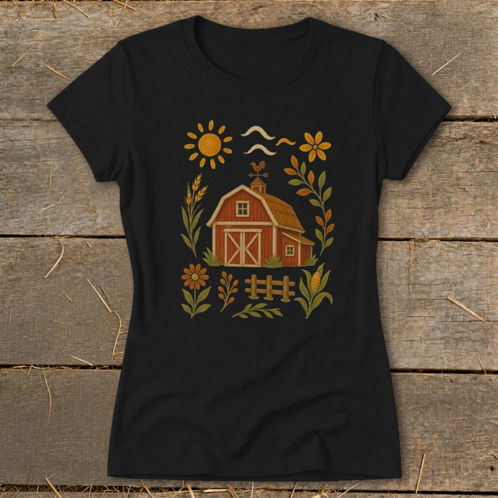 Black t-shirt with a rustic farm scene graphic featuring a red barn, sun, and flowers.