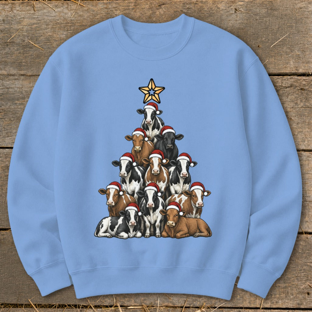 Light blue sweatshirt with cows arranged as a Christmas tree, topped with a star.