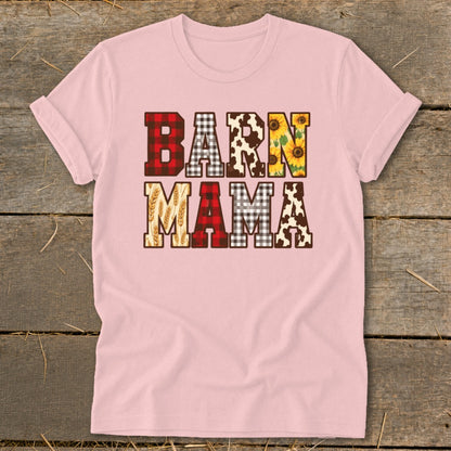 Pink t-shirt with "BARN MAMA" text in block letters with buffalo plaid, cow print, sunflowers, and wheat.