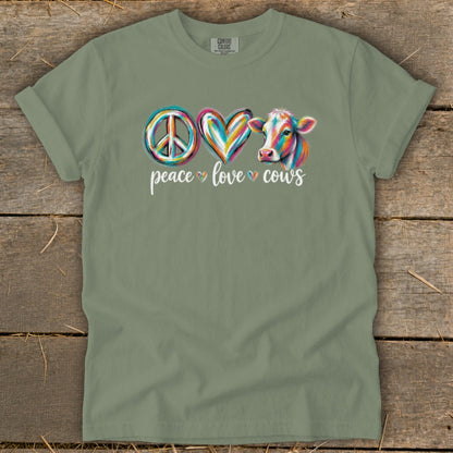 Olive t-shirt with peace sign, heart, and colorful cow design, reading "peace love cows".