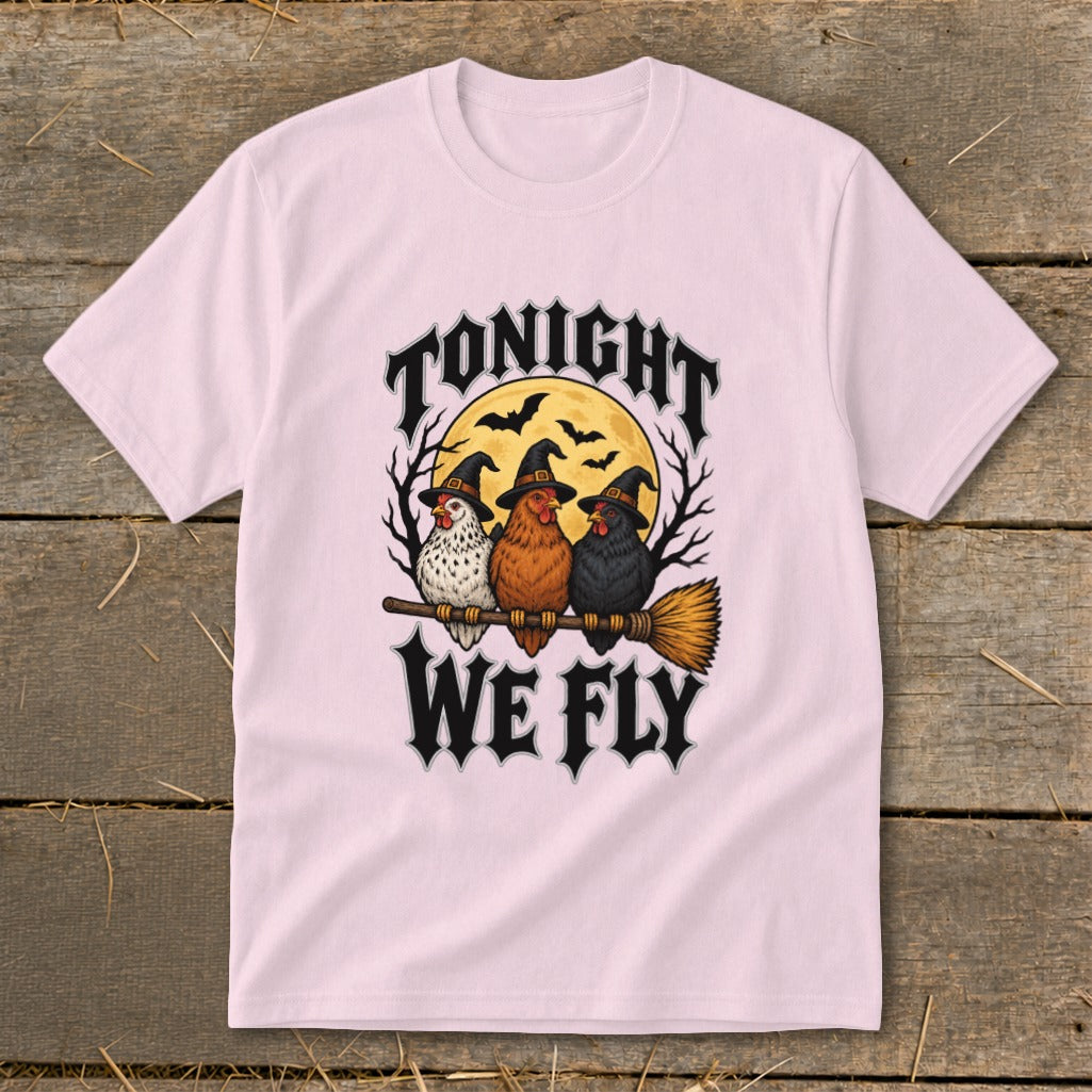 Three chickens in witch hats ride a broomstick under the moon with text "TONIGHT WE FLY."