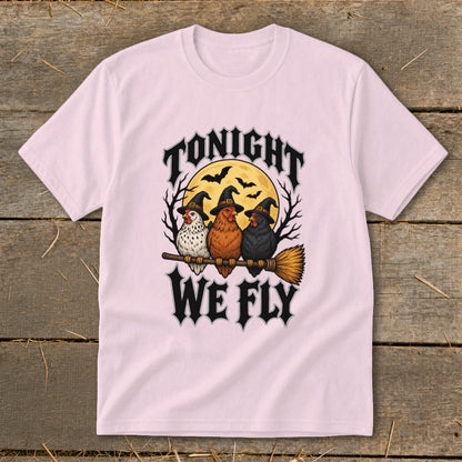 Three chickens in witch hats ride a broomstick under the moon with text "TONIGHT WE FLY."