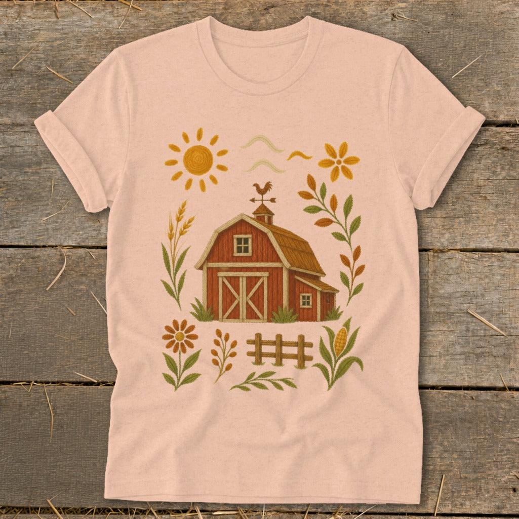 T-shirt with a watercolor-style farm scene including a red barn, sun, and corn.