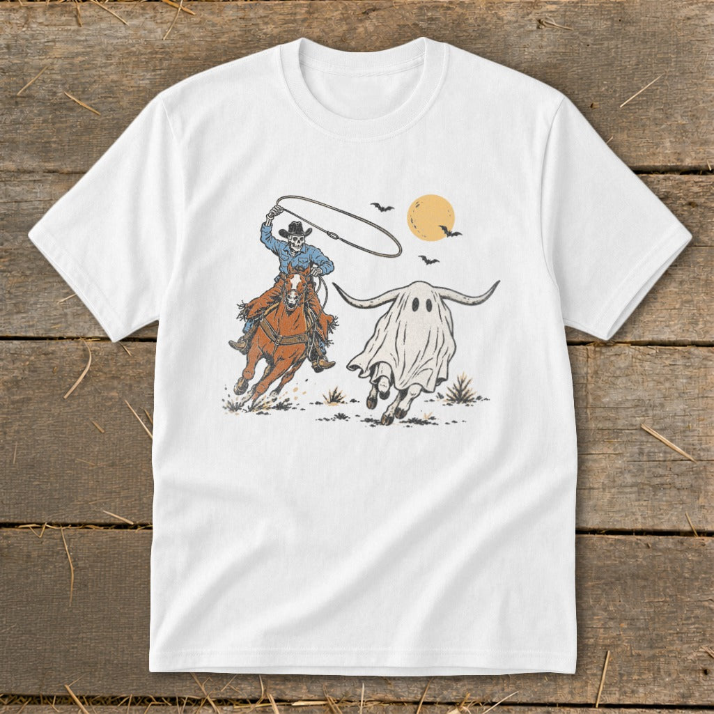 Skeleton cowboy on horse lassoing a longhorn ghost under a full moon.