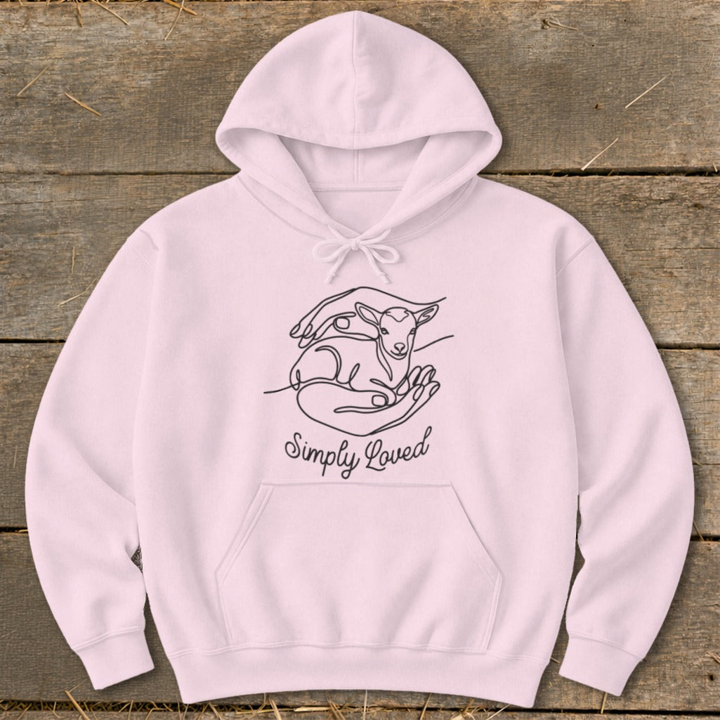 Pink hoodie with line art of hands holding a lamb and text "Simply Loved".