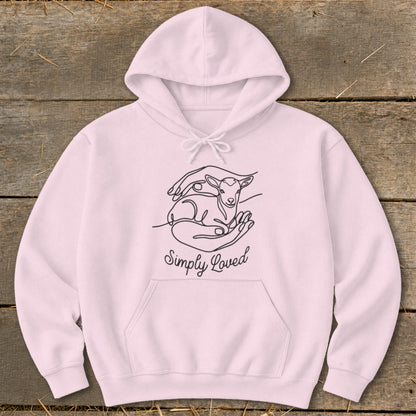 Pink hoodie with line art of hands holding a lamb and text "Simply Loved".