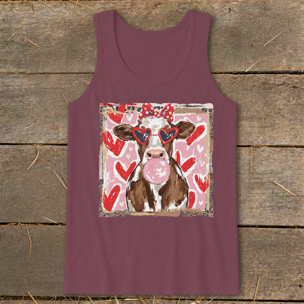 Brown and white cow wearing heart sunglasses and a bow, blowing bubblegum on pink heart background.