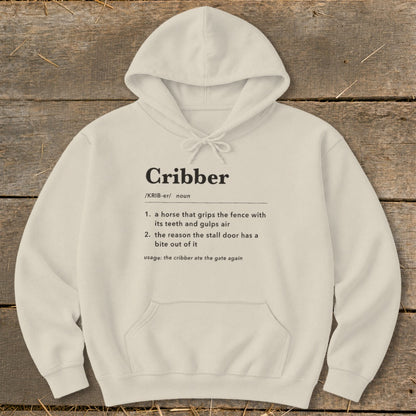Cream-colored hooded sweatshirt with black text defining the word cribber displayed across the chest.