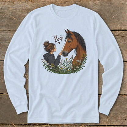 Illustration of a girl booping a horse's nose surrounded by flowers with text "Boop."