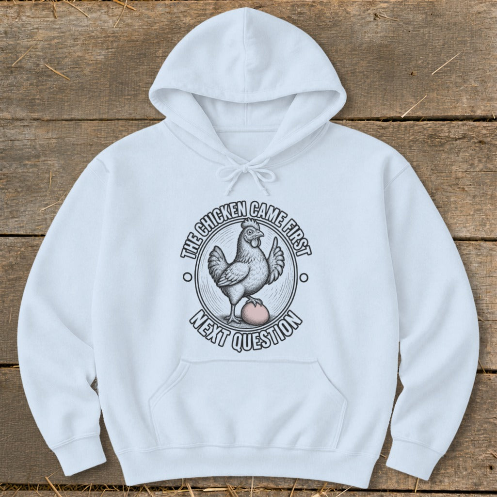 White hoodie with graphic of a chicken on an egg, reading "The chicken came first, next question."