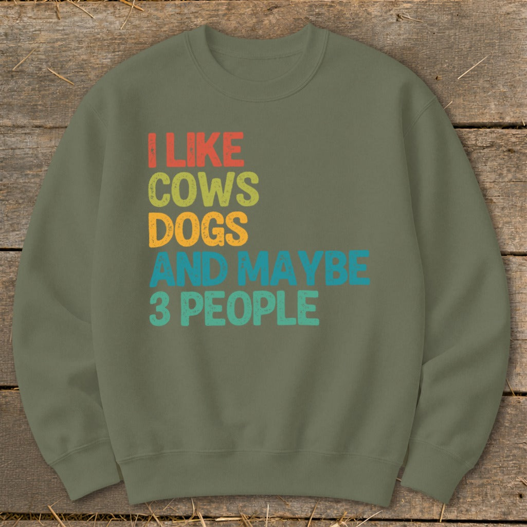 Olive green sweatshirt with "I like cows dogs and maybe 3 people" text.