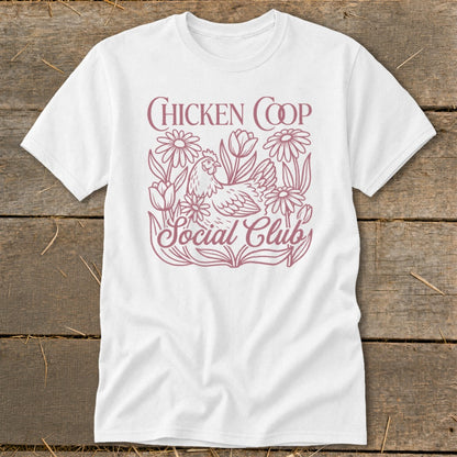 White t-shirt with pink "Chicken Coop Social Club" text and chicken among flowers graphic.