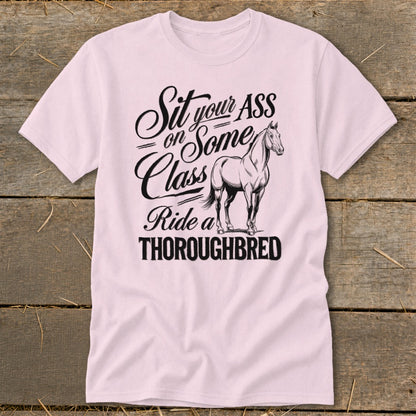Pink t-shirt with text "Sit your ASS on Some Class Ride a THOROUGHBRED" and a horse.