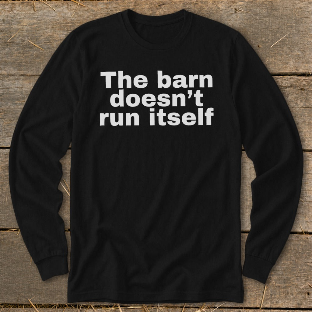 Black long-sleeve shirt with white text that reads "The barn doesn't run itself".