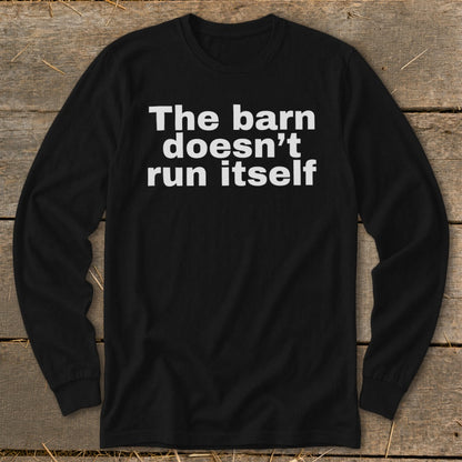 Black long-sleeve shirt with white text that reads "The barn doesn't run itself".