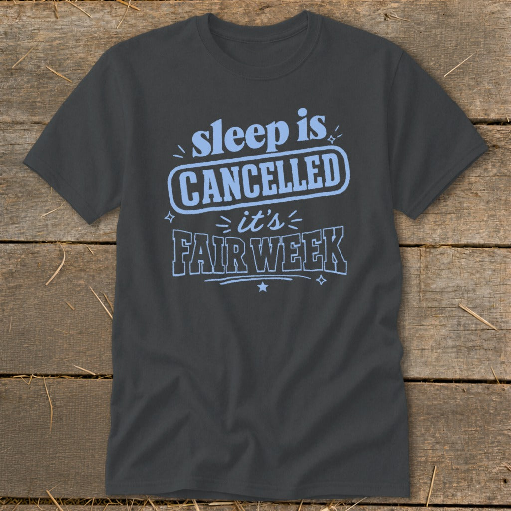 Dark grey t-shirt with light blue text "sleep is CANCELLED it's FAIR WEEK".