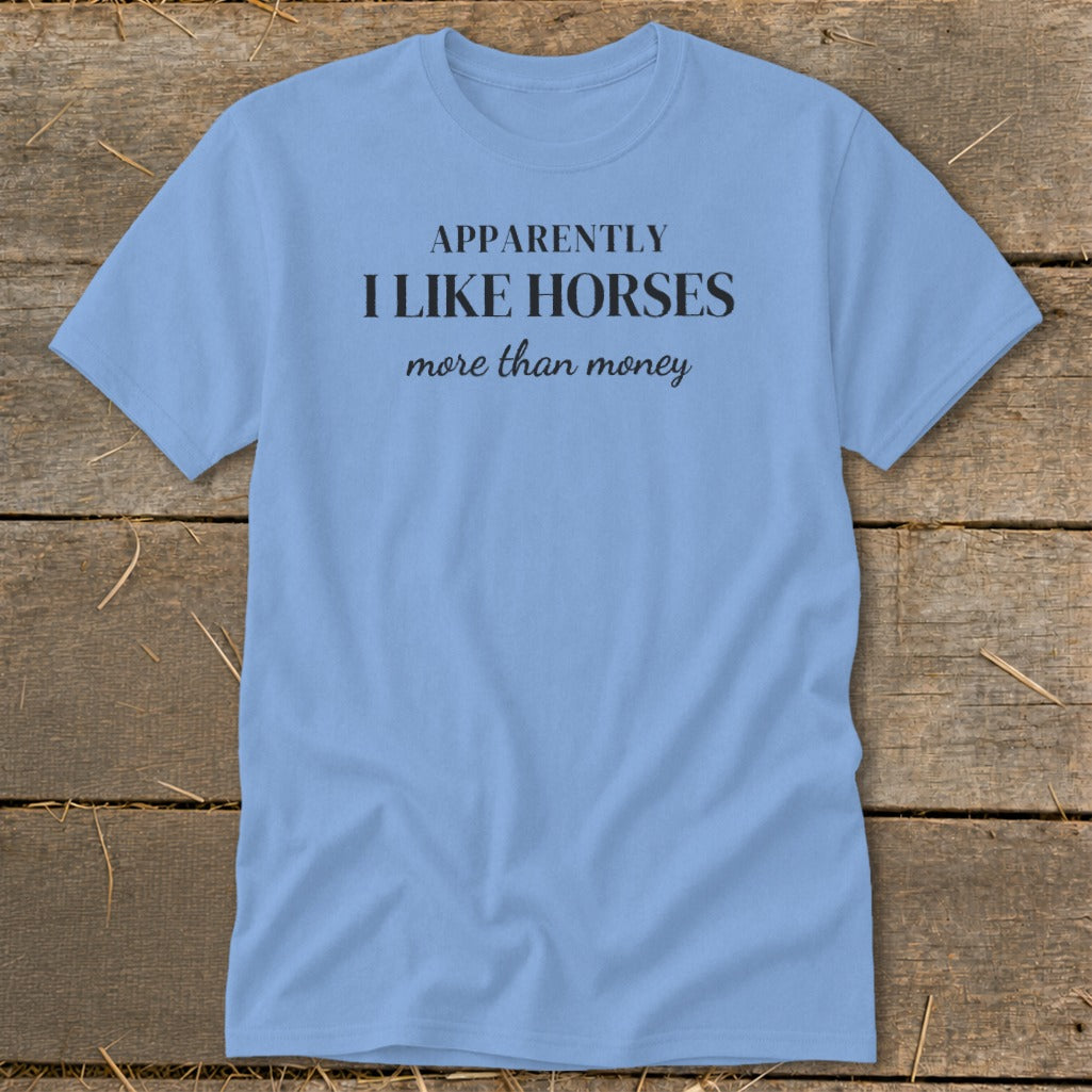 Light blue t-shirt with black text that reads "APPARENTLY I LIKE HORSES more than money."