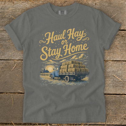 Gray t-shirt with yellow text "Haul Hay or Stay Home" and truck carrying hay bales.