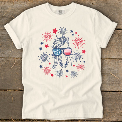 Cream t-shirt with horse wearing American flag sunglasses surrounded by fireworks.