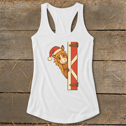 Cartoon horse wearing Santa hat peeking around a barn door on a white tank top.