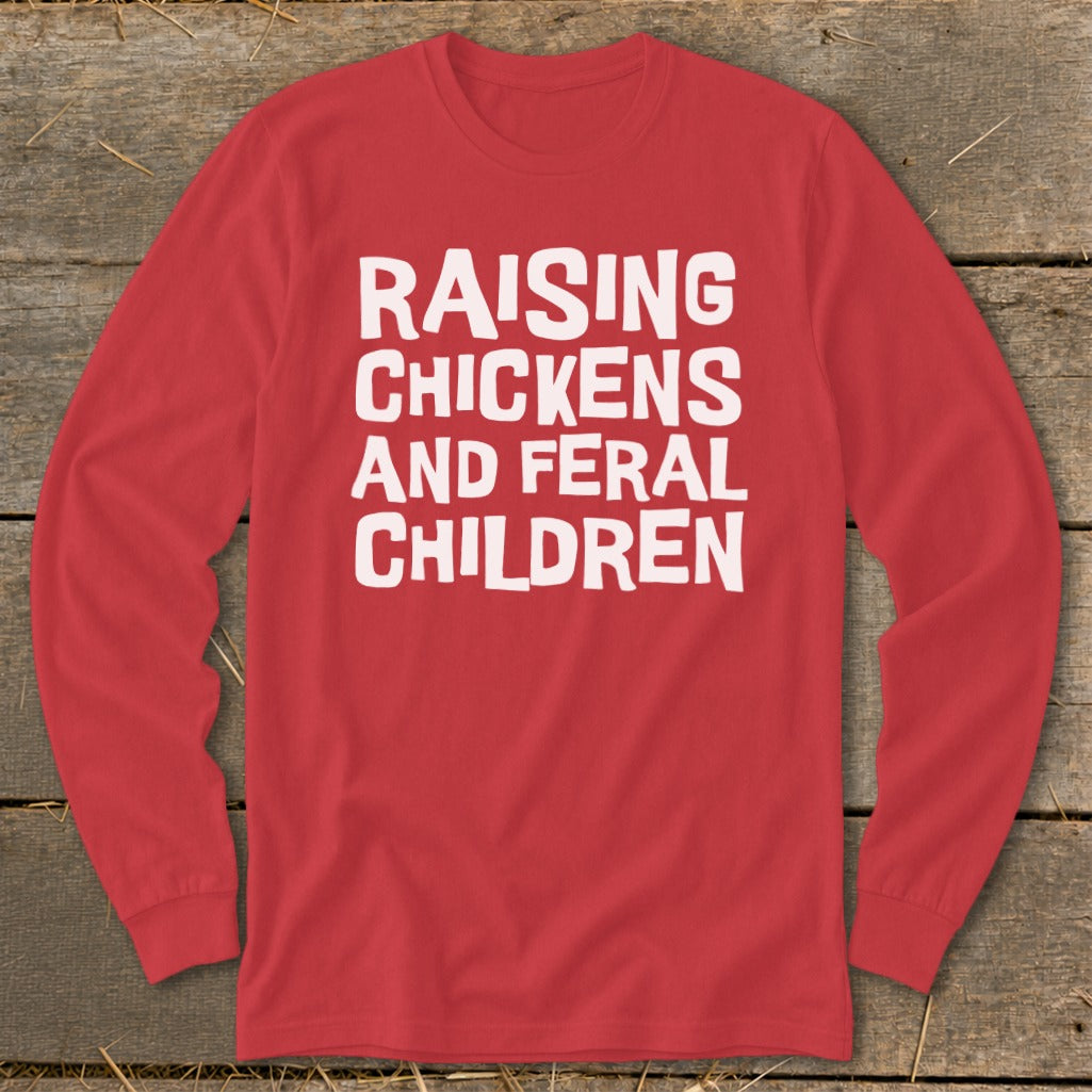 Red long sleeve shirt with white text: Raising Chickens And Feral Children