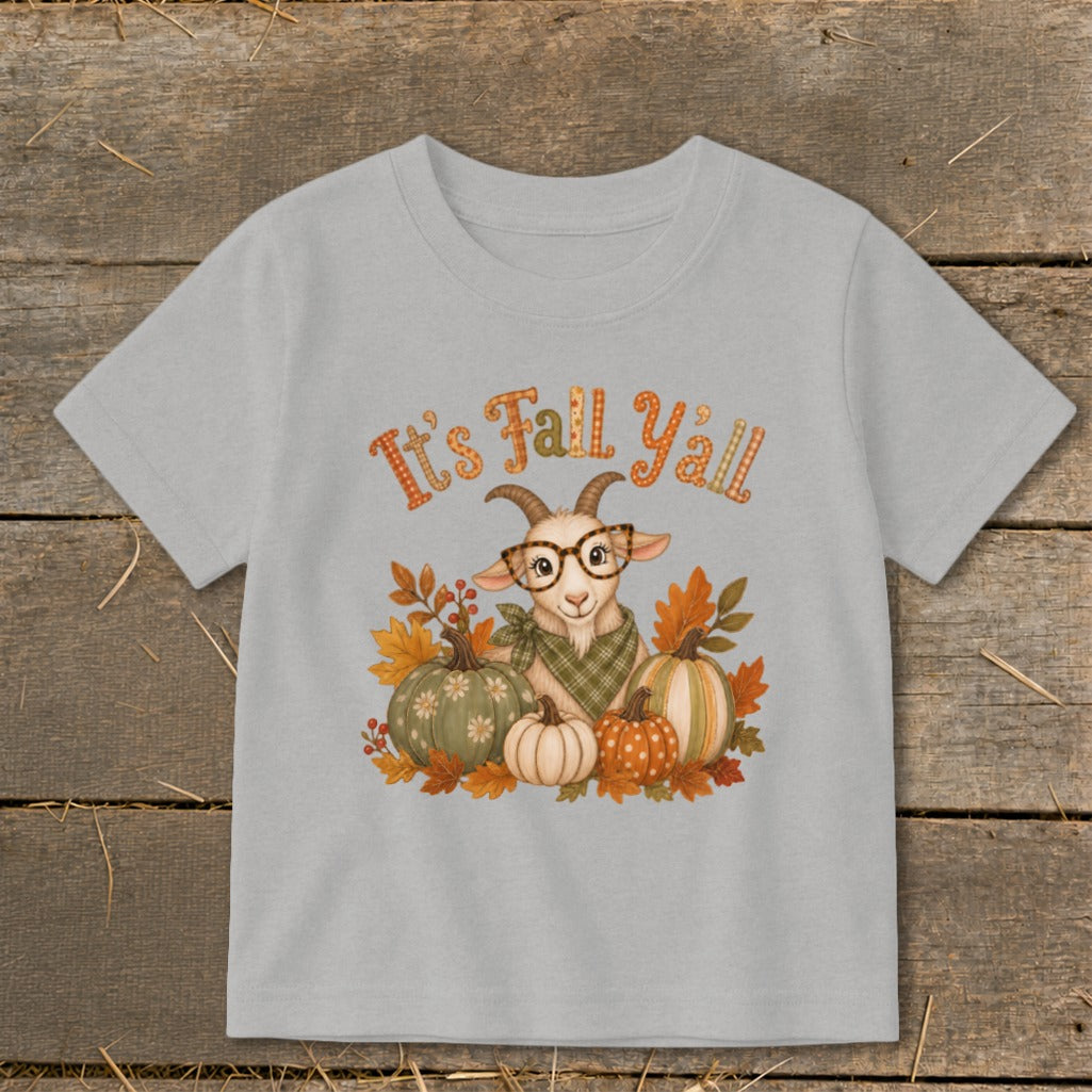 Light gray t-shirt with a cute goat, pumpkins, and fall leaves graphic that says "It's Fall Y'all."