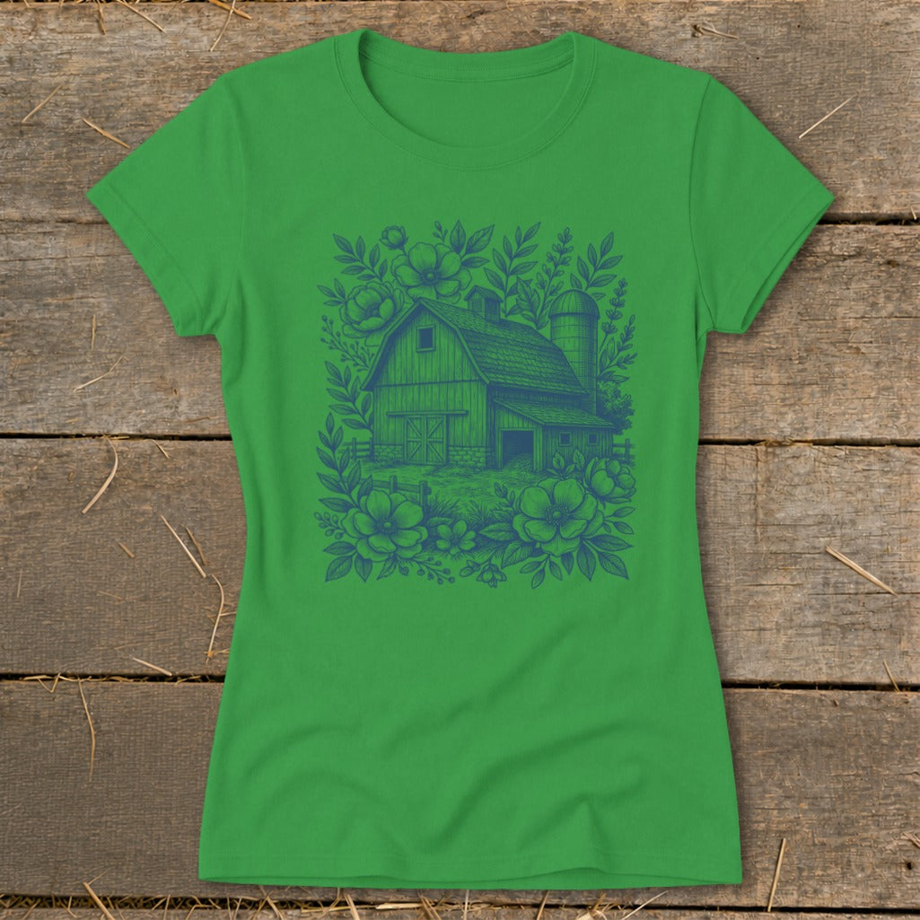 Green t-shirt with blue barn and floral sketch graphic.