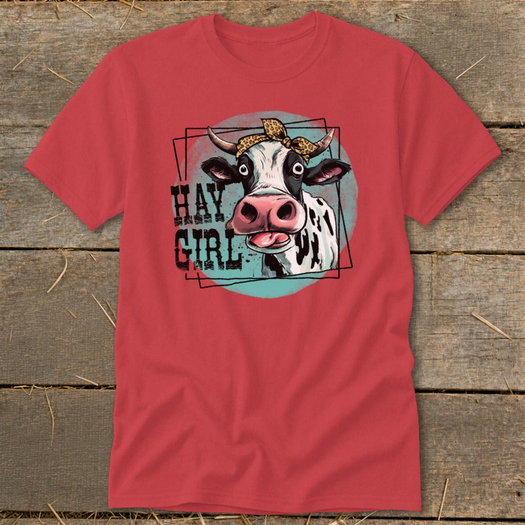 Red t-shirt with a cartoon cow wearing a bandana and the text "Hay Girl".