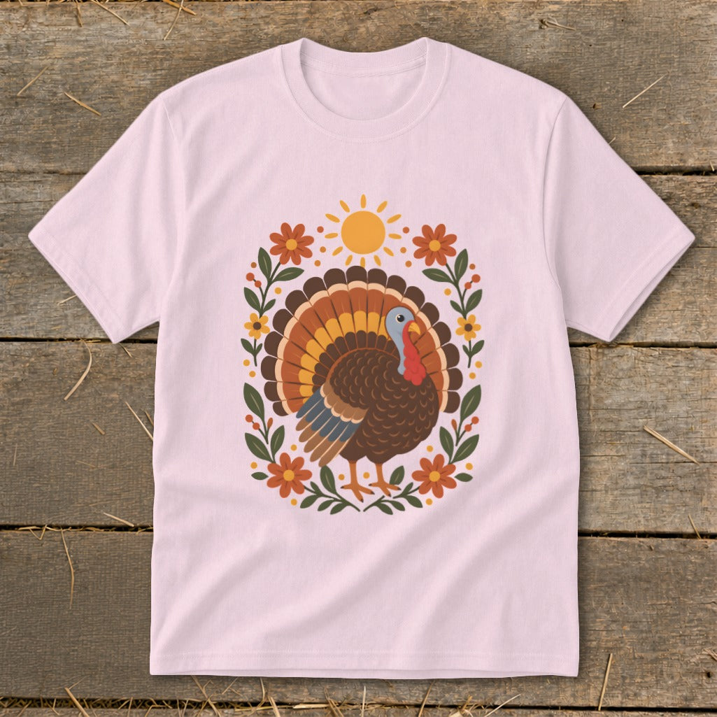 Pink t-shirt with a colorful turkey and floral sunburst design.