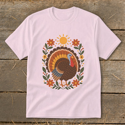 Pink t-shirt with a colorful turkey and floral sunburst design.