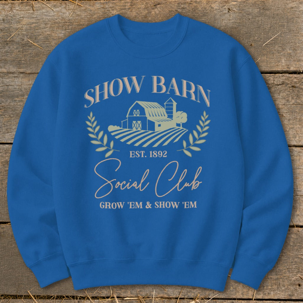 Blue sweatshirt with "Show Barn Social Club Est. 1892" text and barn graphic.