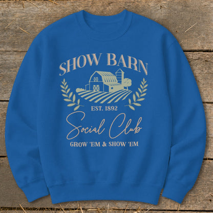 Blue sweatshirt with "Show Barn Social Club Est. 1892" text and barn graphic.