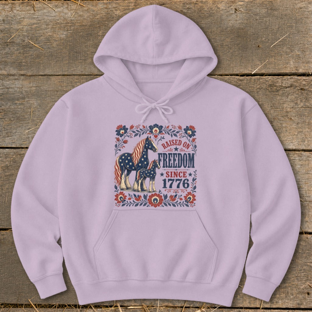 Light purple hoodie with "Raised on Freedom Since 1776" and horse graphic.
