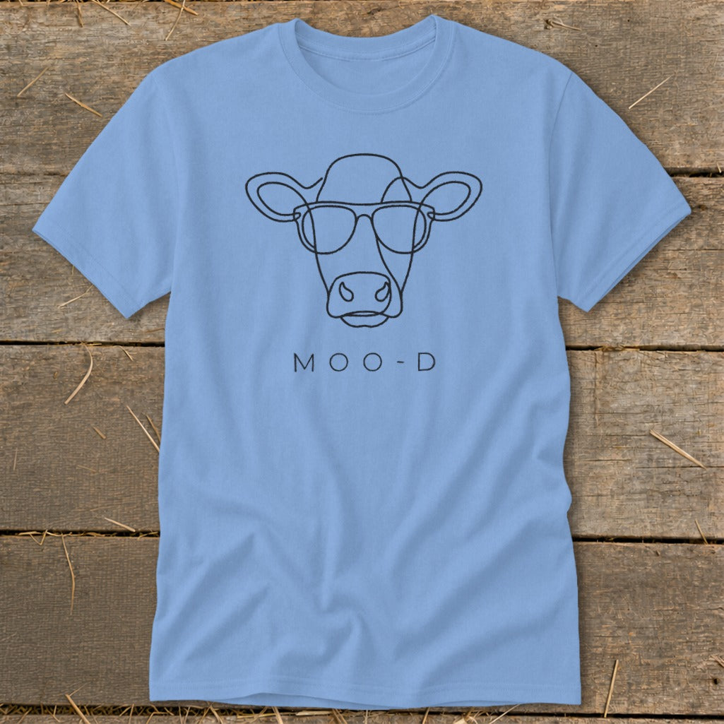 Light blue t-shirt with a minimalist black line drawing of a cow wearing glasses and text "MOO-D".