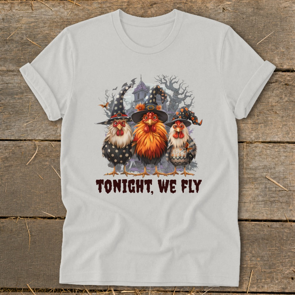 Three chickens in witch hats and a spooky background with text.